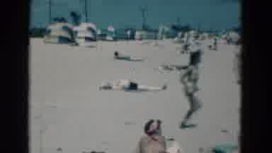 Florida USA (1975): A Child Is Run In The Beach And Some People Are Sleep On The