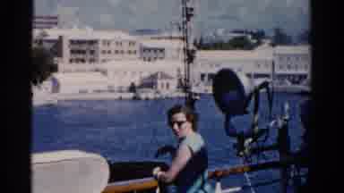 Florida USA (1975): A Lady Looks At Buildings Over The Water By A Railing