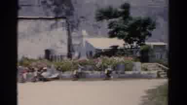 Florida USA (1975): Outdoor Scene Of A Small Town With People Sitting And A White