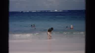 Florida USA (1975): Swimmers And Sunbathers At Beach Woman Wearing Shorts In Low