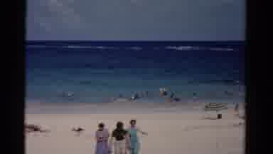 Florida USA (1975): People Walking Towards The Camera While Others Are Swimming On