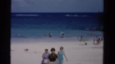 Florida USA (1975): Women Walking Off Of A Beach On A Clear Sunny Day And A Green