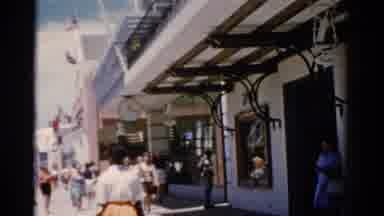 Florida USA (1975): People Are Walking On The Road There Is A Large Shop Nearby