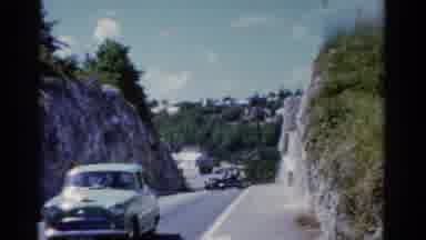 Florida USA (1975): Classic Cars Driving Through A Narrow Road Surrounded By