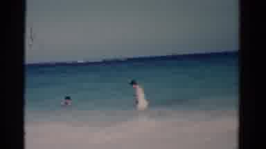 Florida USA (1975): Two People Swimming In The Clear Blue Waters Of The Ocean