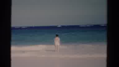 Florida USA (1975): Woman Stands Knee Deep In Sea Waves Gazing Into Horizon Then