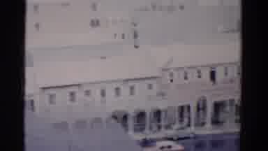 Florida USA (1975): People Strolling Along While Cars Pass And Buildings Along The