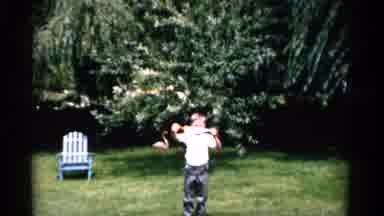 Florida USA (1975): Young Boy Walks Towards The Camera And Shows Off His Small