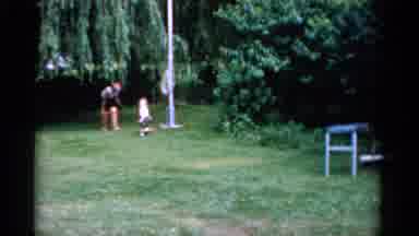 Florida USA (1975): Mother And Child Play Outside On The Grass On A Summer Day