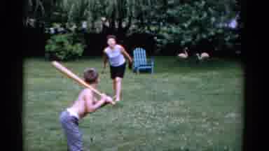 Florida USA (1975): Woman With Mitt Underhand Pitches To Young Boy Swing Bat While