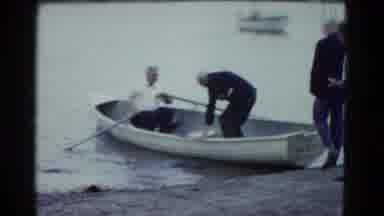 BOSTON MASS USA-1975: Older Men Board And Row Boat On Lake