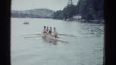 Boston Mass USA (1975): Four Men Rowing On A Lake Surrounded By Pines On An