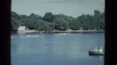 Boston Mass USA (1975): People In Green Boat Watching A Scull Row Boat Race On