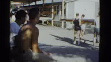 Boston Mass USA (1975): Men Carrying A Large And Long Object While Other Men Watch