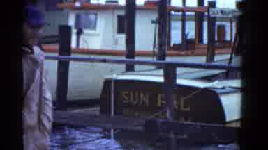 Boston Mass USA (1975): Men Walk Past Sun Pal Boat Sign On A Windy Day