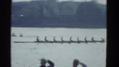 Boston Mass USA (1975): Two Teams Of Rowers Race Across The Lake As Other On The