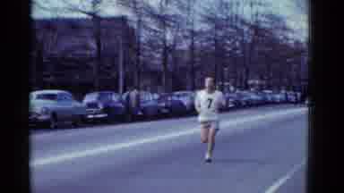 Boston Mass USA (1975): Two Joggers Running Down The Road With Cars Parked Along