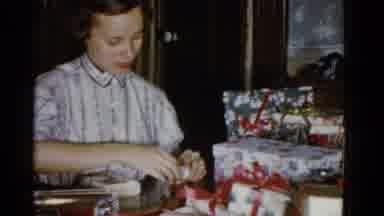 Boston Mass USA (1975): A Lady Sitting At A Table Wrapping Christmas Gift
