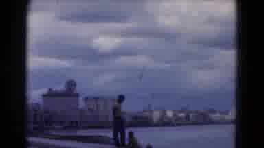 FLORIDA USA-1975: City Skyline Panning Harbor Gentleman On Shore Cloudy Gray Sun