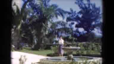Florida USA (1975): Woman Walk By Water Fountain And Waves To The Camera Then