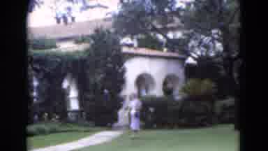 Florida USA (1975): A Woman Walking Across The Lawn Into The Pave Walkway