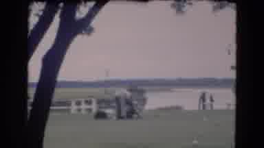 Florida USA (1975): Man Speaking To Another Man Kneeling On The Grass In Front Of
