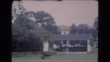 Florida USA (1975): Cars Parked At Tan And Red Buildings On A Cloudy Day