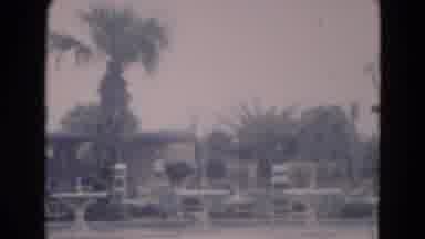 Florida USA (1975): Person Walking In Front Of A House And Palm Trees At The Beach