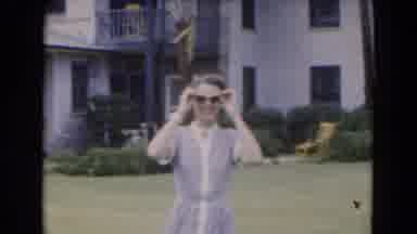 Florida USA (1975): Young Woman Takes Off Her Sunglasses As She Walks Outside In