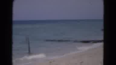Florida USA-1975: A Woman Wading Into The Ocean At The Beach