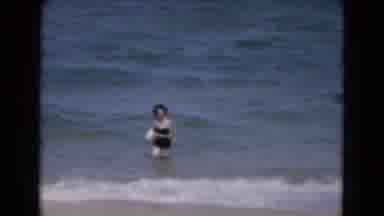 Florida USA (1975): Woman In Black Bathing Suit Runs Free From The Ocean Waves