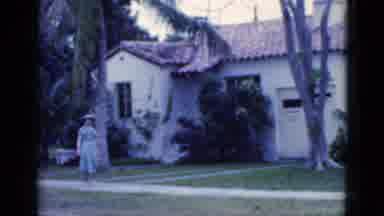Florida USA (1975): Woman In A Pretty Sundress And Hat Strolling Down A Palm Tree