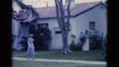 Florida USA (1975): Well Dressed Woman Strolls Down The Walkway Past A House