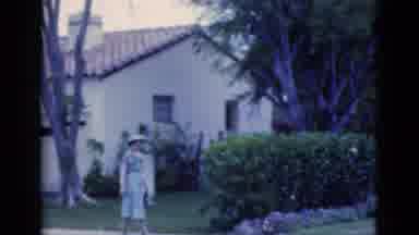 Florida USA (1975): Woman In Hat And Dress Walks Down The Path Around The Garden