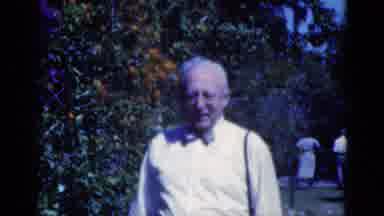 Florida USA (1975): Person Walks Underneath Shade Tree While Man Wearing White