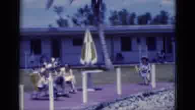 Florida USA (1975): A Pool Area Depicting People Sunning Themselves In Front Of A