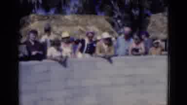 FLORIDA USA-1975: Camera Pans Across Tourists Standing Behind a Gray Wall