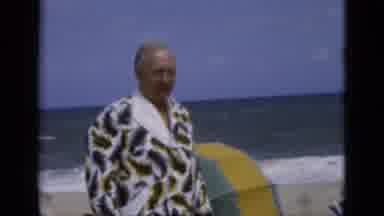 Florida USA (1975): Man Dressing Gown Sea Walking Rough Windy Trunks Talking Swim