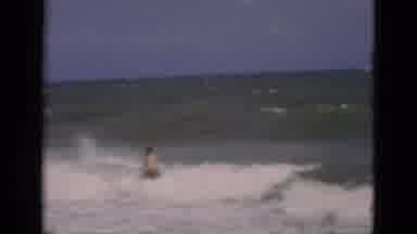 Florida USA (1975): Male Bather Walking Into Waves Then Walking Back