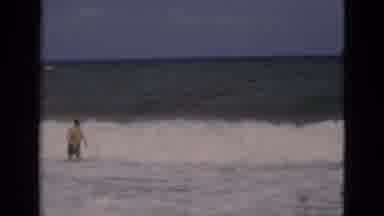 Florida USA (1975): Man Walks Through Crashing Sea Waves On A Bright Sunny Day