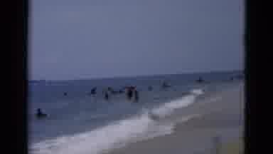 Florida USA (1975): Large Group Of People Frolicking On The Beach And In The Ocean