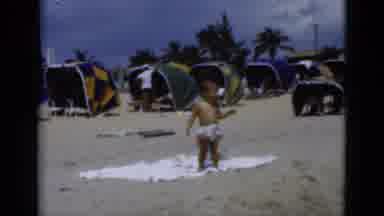 Florida USA (1975): Very Small Child Enjoying Beautiful Sunny Day On The Crowded