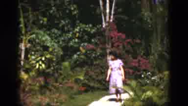 Florida USA (1975): A Women Walking In The Garden And Seeing The Flowers