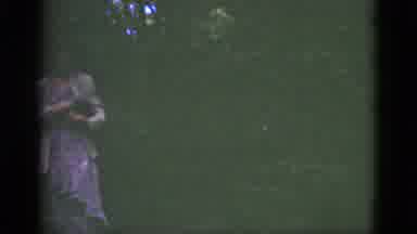 Florida USA (1951): Female Walking In Dark Greenery Carrying Small Animal In Left