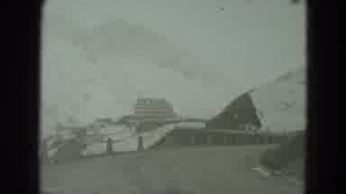 West Germany (1951): View Of Snow Covered Mountains And People Walking On Snow On