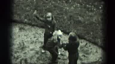 West Germany (1951): Girl Stands In Field While Other Children Play Game Of Keep
