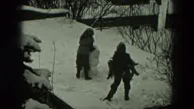 West Germany (1951): Three Kids In Thick Coats Hats And Gloves Work Together To