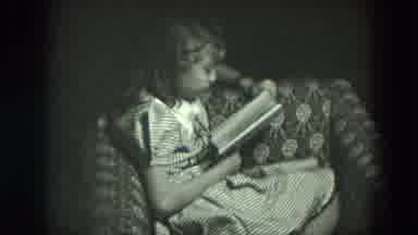 West Germany (1951): Girl Sits In Chair Reading Book While Others Smile And Dance