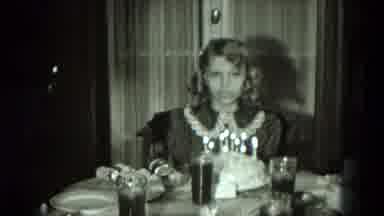 West Germany (1951): Young Girl Blowing Out Birthday Cake Candles And Smiling At