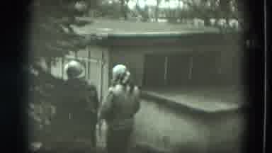 West Germany (1951): Couple Walking Past Old Housing Units
